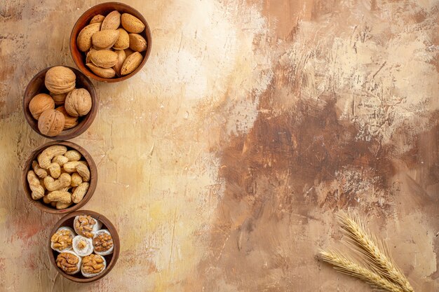 Top view of fresh various nuts lined on a wooden desk