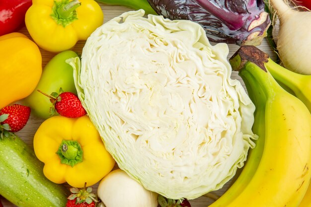 Top view fresh vegetable composition with fruits on white desk