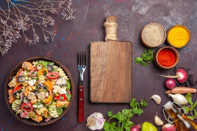 Free photo top view of fresh vegetable. salad with different seasonings on black