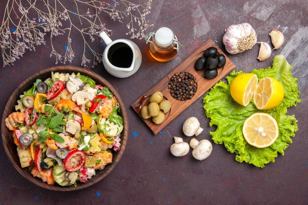 Top view of fresh vegetable. salad with lemon slices on black