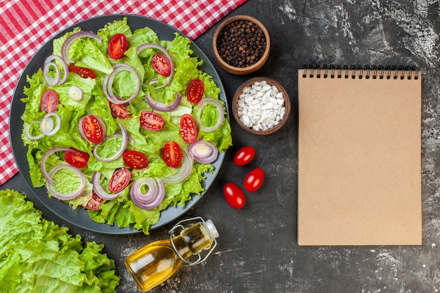 Top view fresh vegetable salad with onions green salad and tomatoes on gray background health color ripe salad food diet meal photo