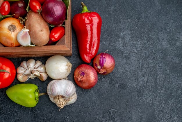 Top view fresh vegetables composition on dark table salad fresh ripe color