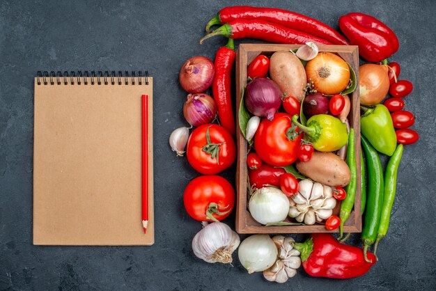 Top view fresh vegetables composition on grey table salad fresh ripe color