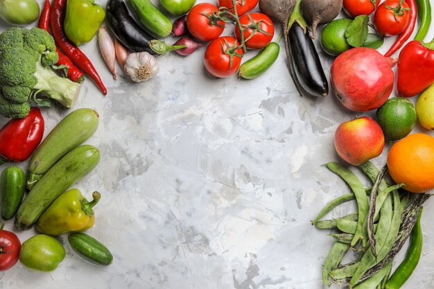 Top view fresh vegetables composition on light-white background