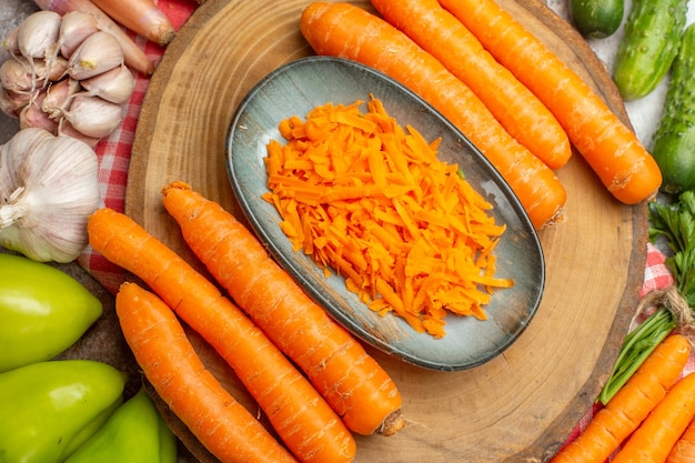 Top view fresh vegetables composition with carrot on white background