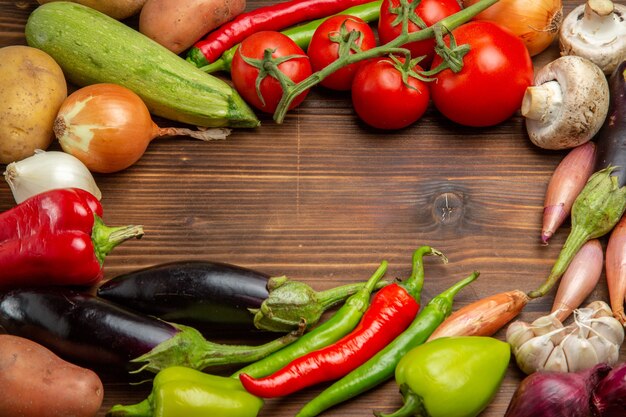 Top view fresh vegetables composition on wooden desk