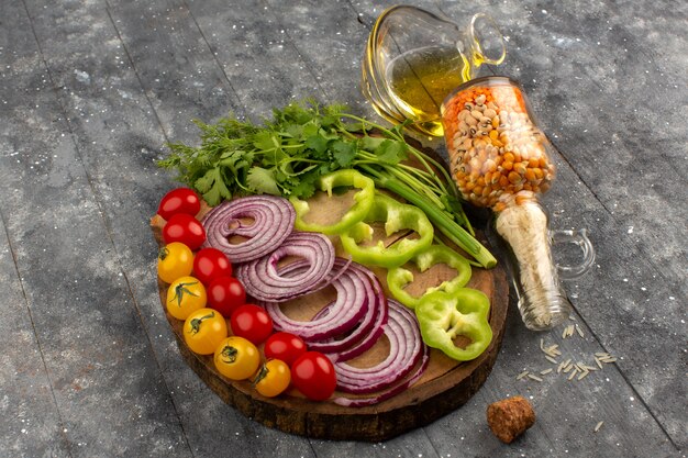 top view fresh vegetables sliced and whole on the grey floor