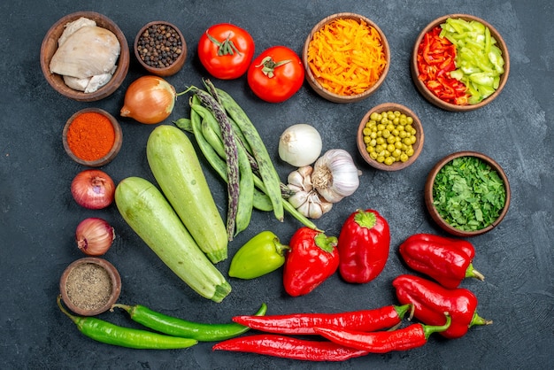 Top view fresh vegetables with beans and seasonings on dark table salad meal ripe