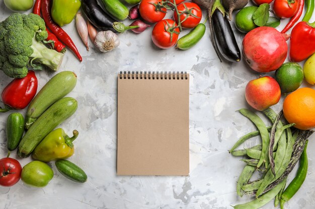 Top view fresh vegetables with fruits on white background