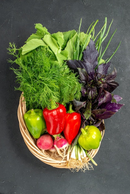 Top view fresh vegetables with greens on a dark background