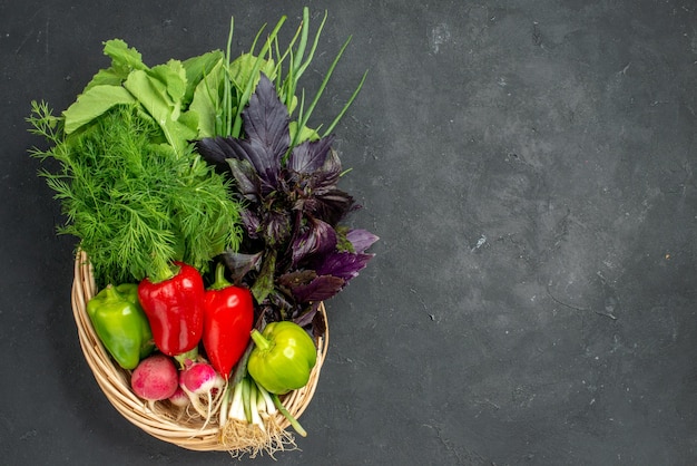 Top view fresh vegetables with greens on dark background