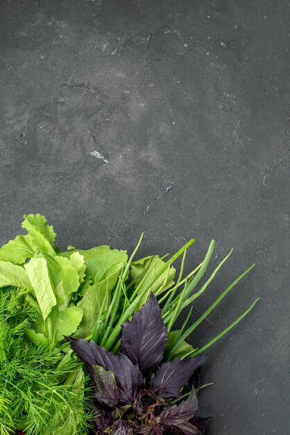 Top view fresh vegetables with greens on the dark background