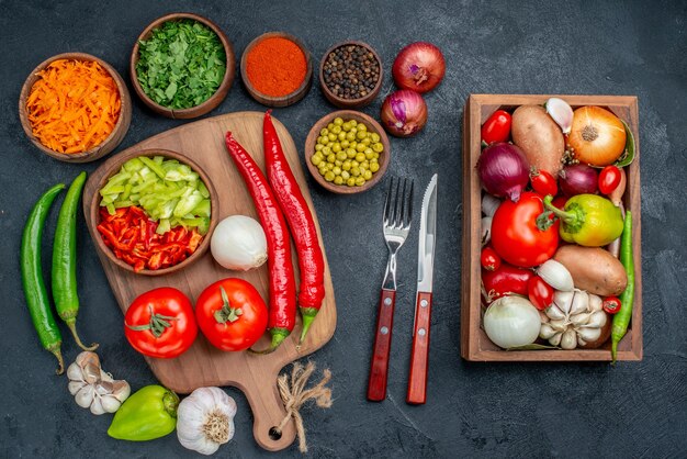 Top view fresh vegetables with greens on dark desk salad vegetable ripe color