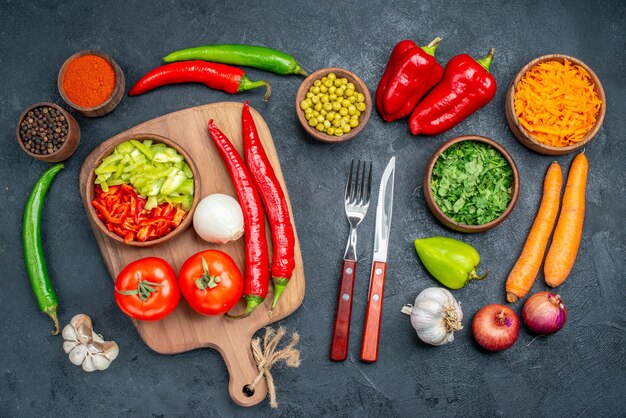 Top view fresh vegetables with greens on dark table ripe salad vegetables