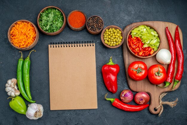 Top view fresh vegetables with greens on dark table vegetables color ripe salad