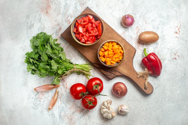 Top view fresh vegetables with greens on a light white space