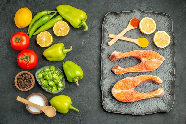 Top view fresh vegetables with meat slices on dark-grey background