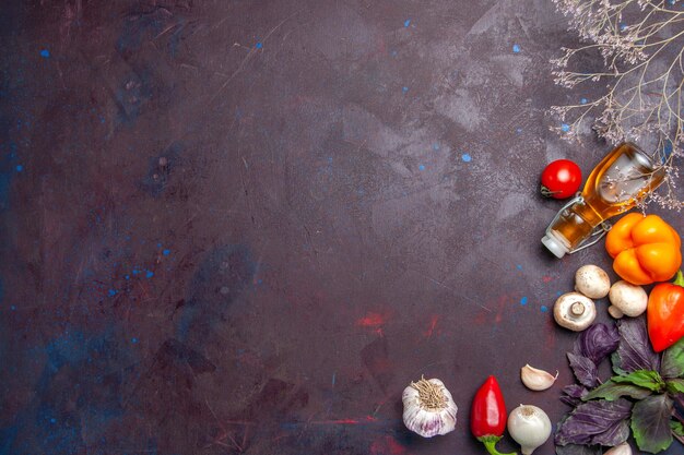 Top view fresh vegetables with oil on dark surface salad health food meal