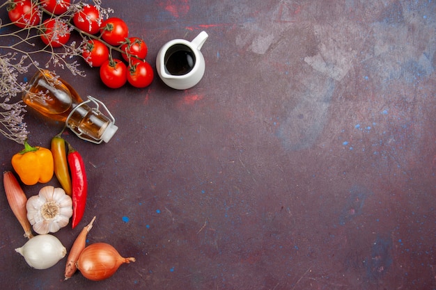 Top view fresh vegetables with olive oil on dark desk