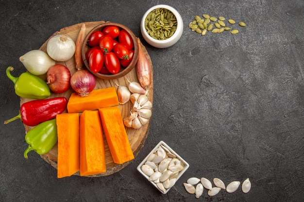 Top view fresh vegetables with pumpkin on dark-grey background ripe color meal fresh salad