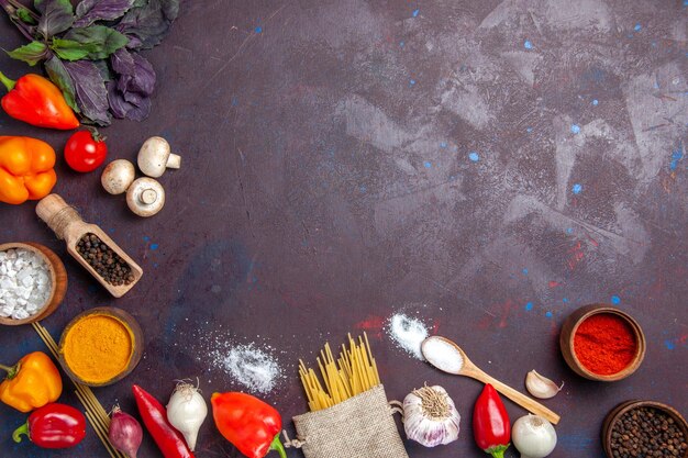 Top view fresh vegetables with raw pasta on dark surface meal food salad pasta