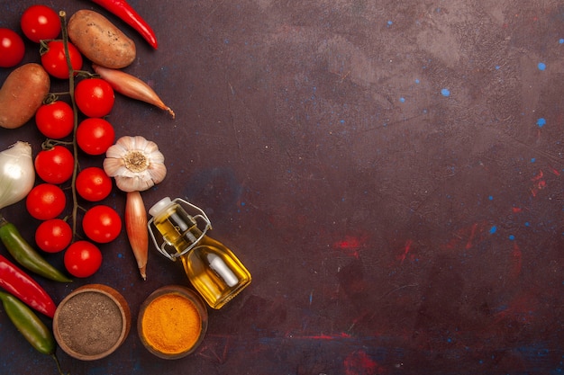 Top view fresh vegetables with seasonings on dark-purple space