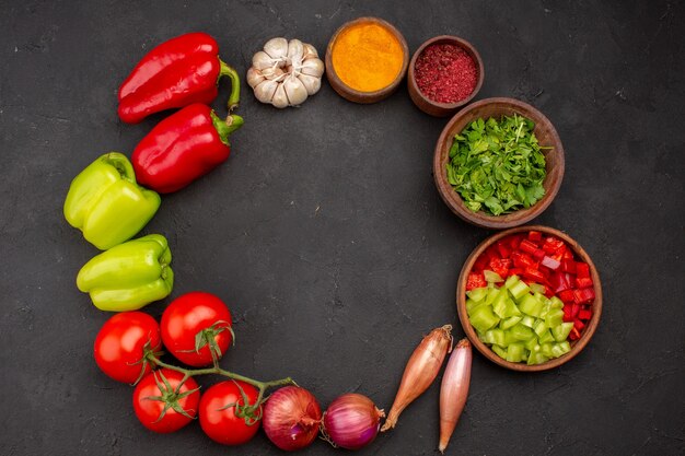 Top view fresh vegetables with seasonings on grey background salad health spicy meal