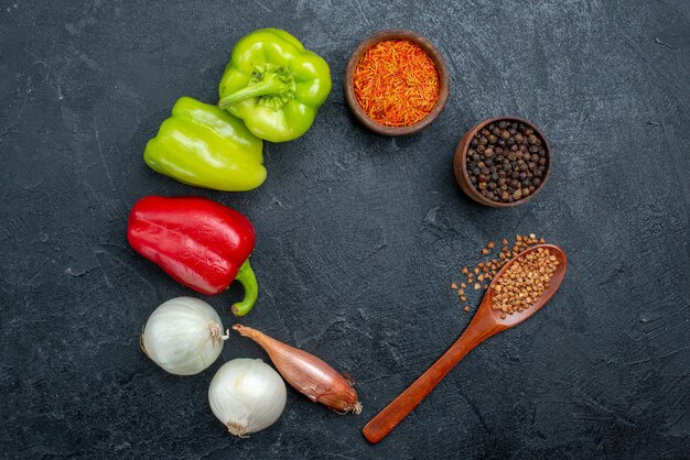 Top view fresh vegetables with seasonings on grey space