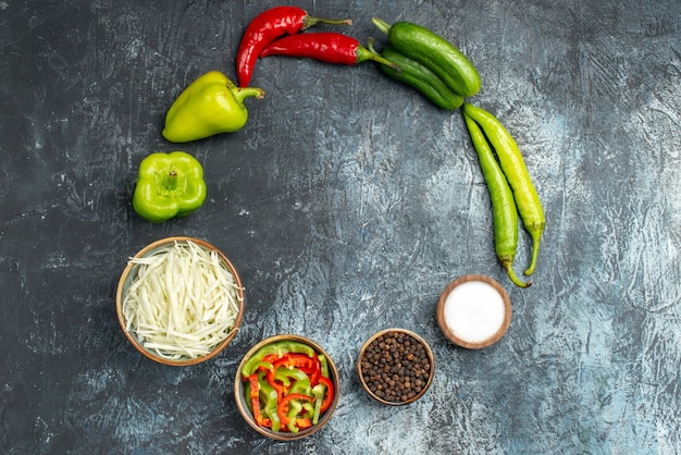 Top view fresh vegetables with sliced cabbage and seasonings on the light-grey background