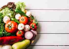 Free photo top view of fresh vegetables on wooden surface