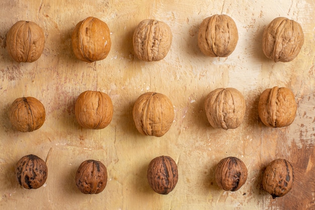 Top view of fresh walnuts lined on a wooden desk