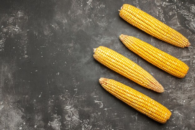 Top view fresh yellow corns on a dark background