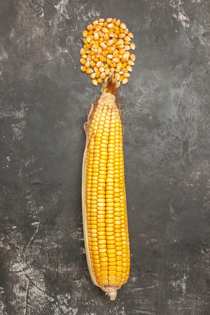 Top view fresh yellow corns on dark background