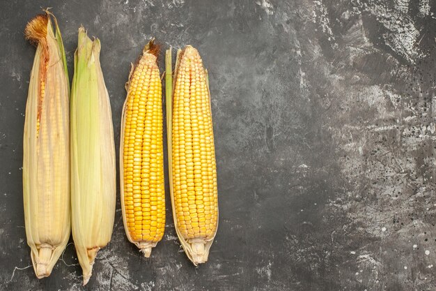 Top view fresh yellow corns on dark background