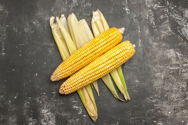 Top view fresh yellow corns on dark background