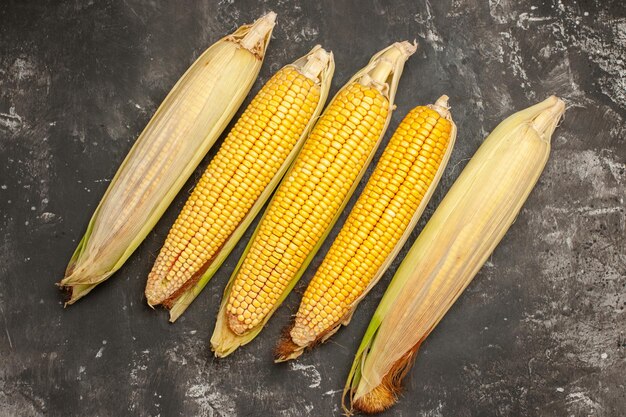 Top view fresh yellow corns on dark background