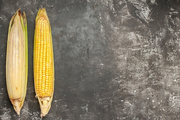 Top view fresh yellow corns on dark background