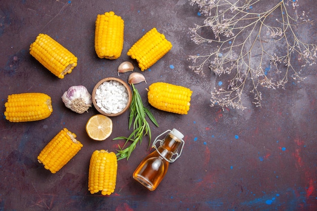 Top view fresh yellow corns raw with oil on dark surface corn snack food raw fresh