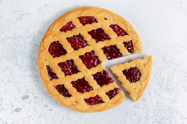 Top view of freshly baked homemade American pie on grey surface. 