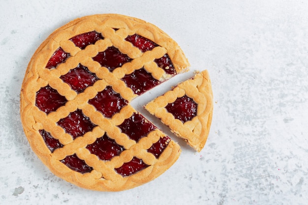 Top view of freshly baked homemade American pie on grey wall.