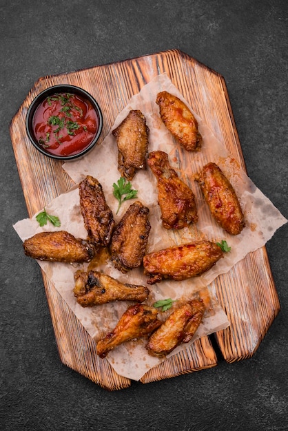 Top view of fried chicken parts with sauce