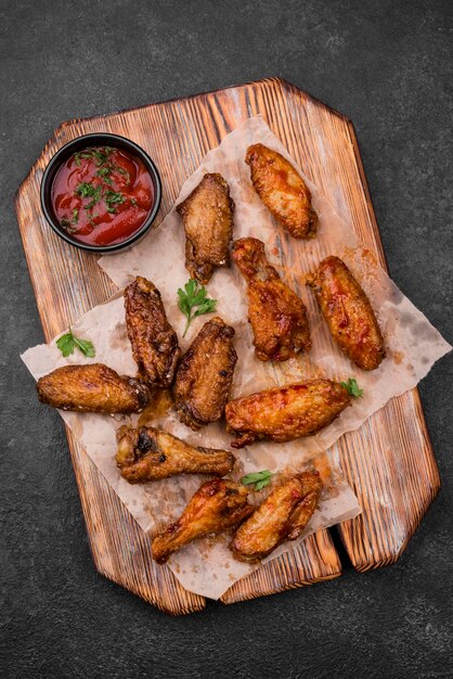 Top view of fried chicken parts with sauce