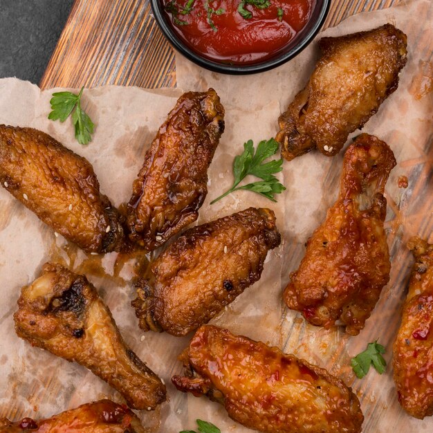 Top view of fried chicken parts with sauce