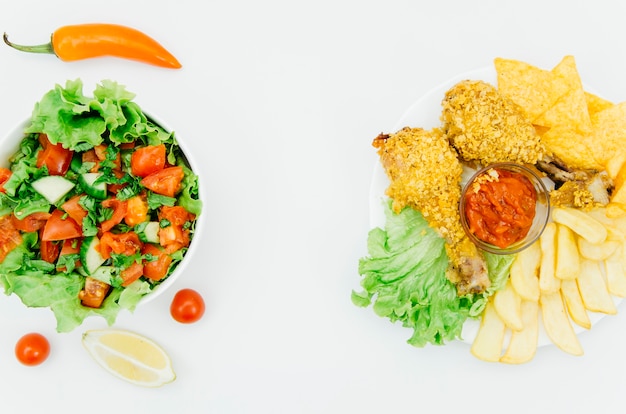 Top view fried chicken vs salad