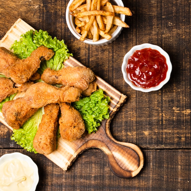 Top view of fried drumsticks with french fries