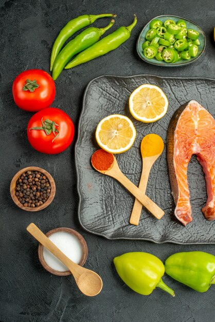 Top view fried meat slices with fresh vegetables on a dark background