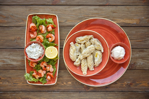 Top view of fried shrimps with lemon and sauce and gurza with yoghurt