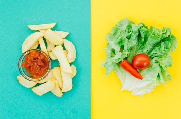 Free photo top view fries vs vegetables