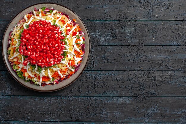 Top view from afar Christmas dish Christmas salad in the plate on the left side of the table