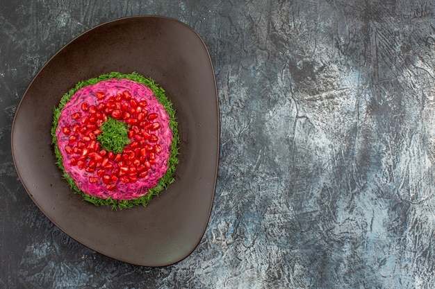 Top view from afar dish plate of an appetizing dish with herbs pomegranate seeds